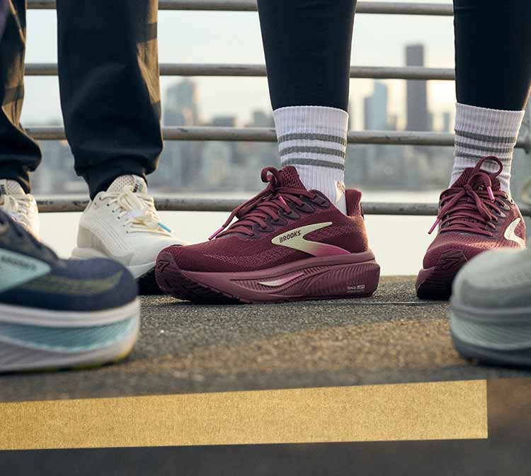A close-up photo of different Brooks shoes on a sidewalk
