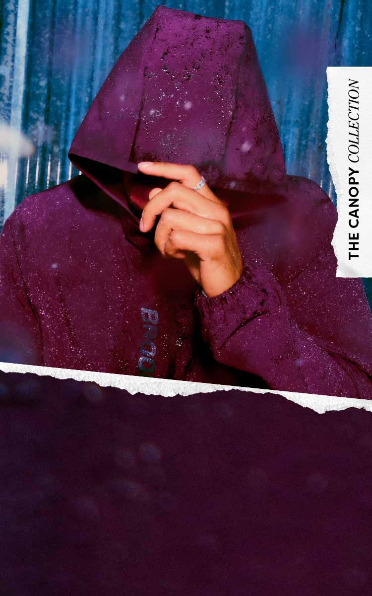 A smiling man wearing purple Brooks gear