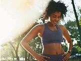 A woman wearing a Brooks bra smiles