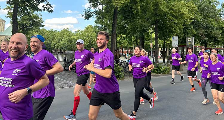 A group of people running and smiling