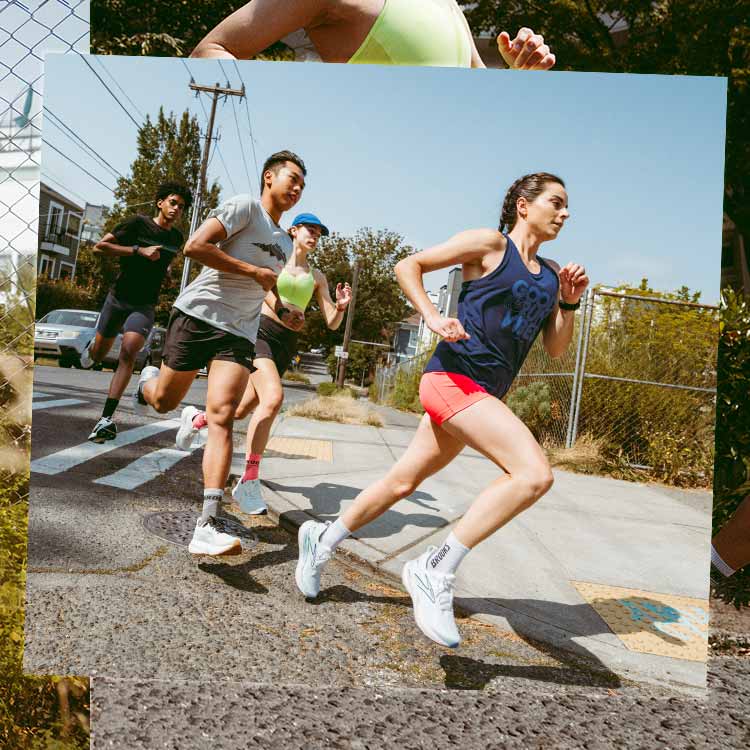 Runners in bright clothing run across a street