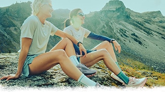 Two trail runners sitting on ground