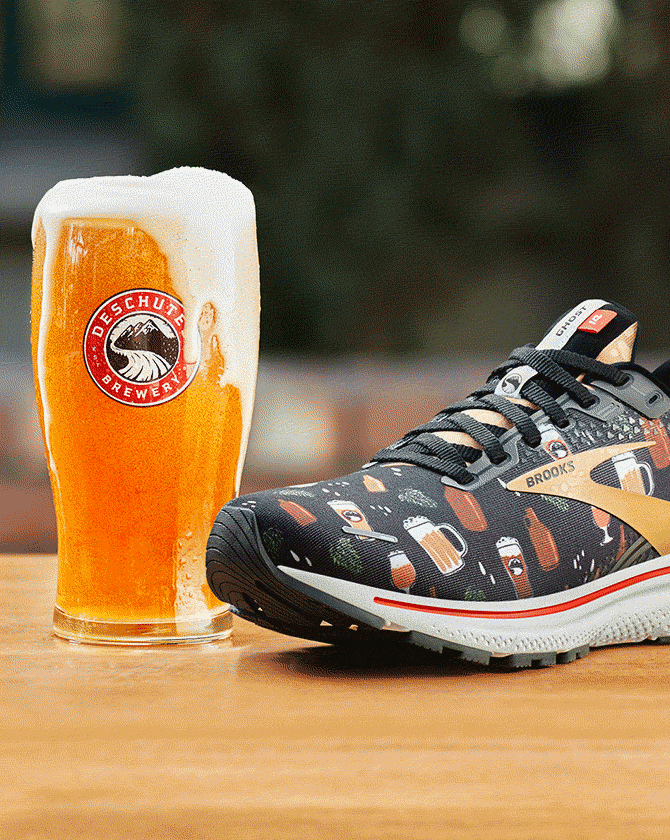 A shoe next to a glass of beer
