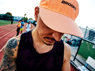 A man wearing a Brooks hat outside