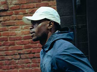 A man wearing Brooks apparel runs outside