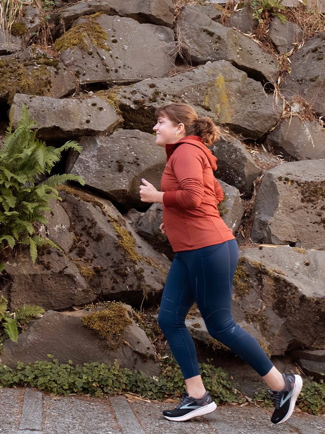Woman running with a rocky background.