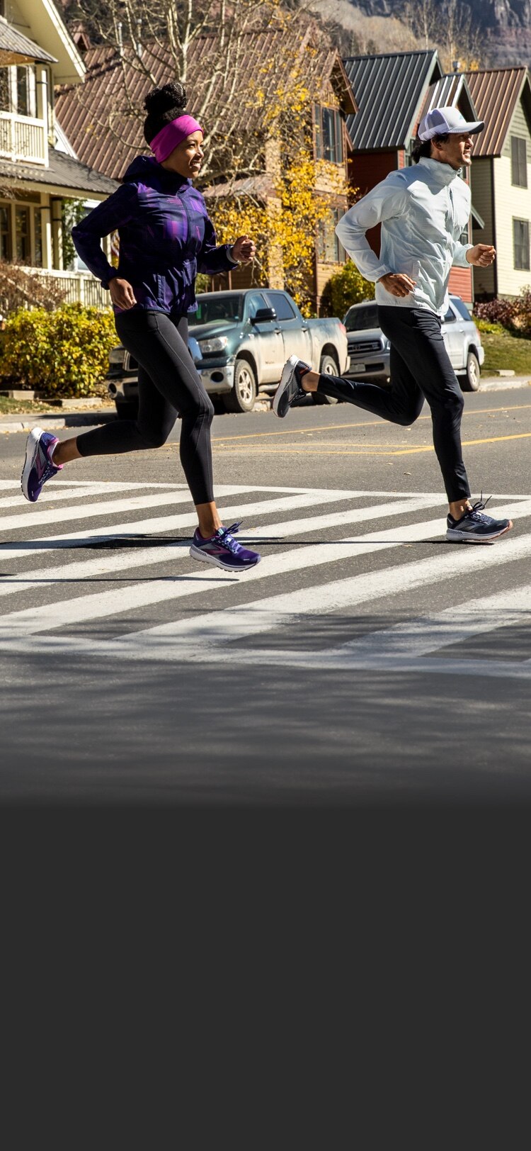 Two runners running across a street
