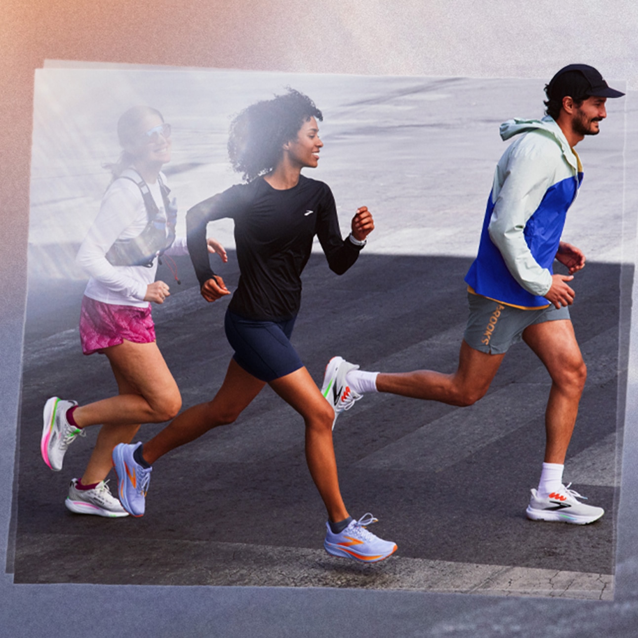 Three people run on a sidewalk.
