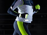 Model wearing the new Brooks reflective gear accessories