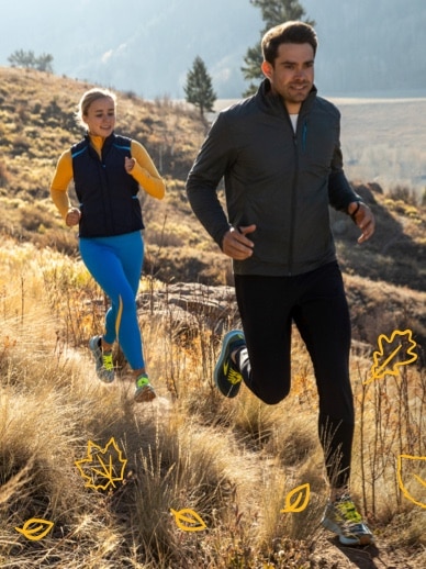 Two people trail running in a Fall landscape