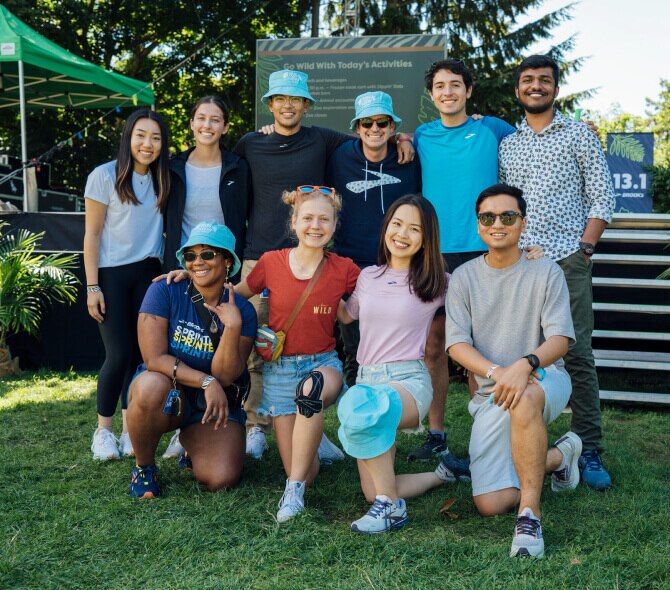 A group of smiling Brooks interns sitting outside