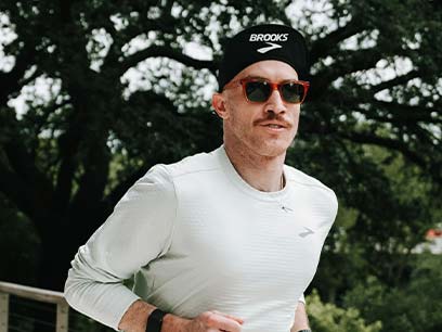 Man running while wearing Brooks apparel