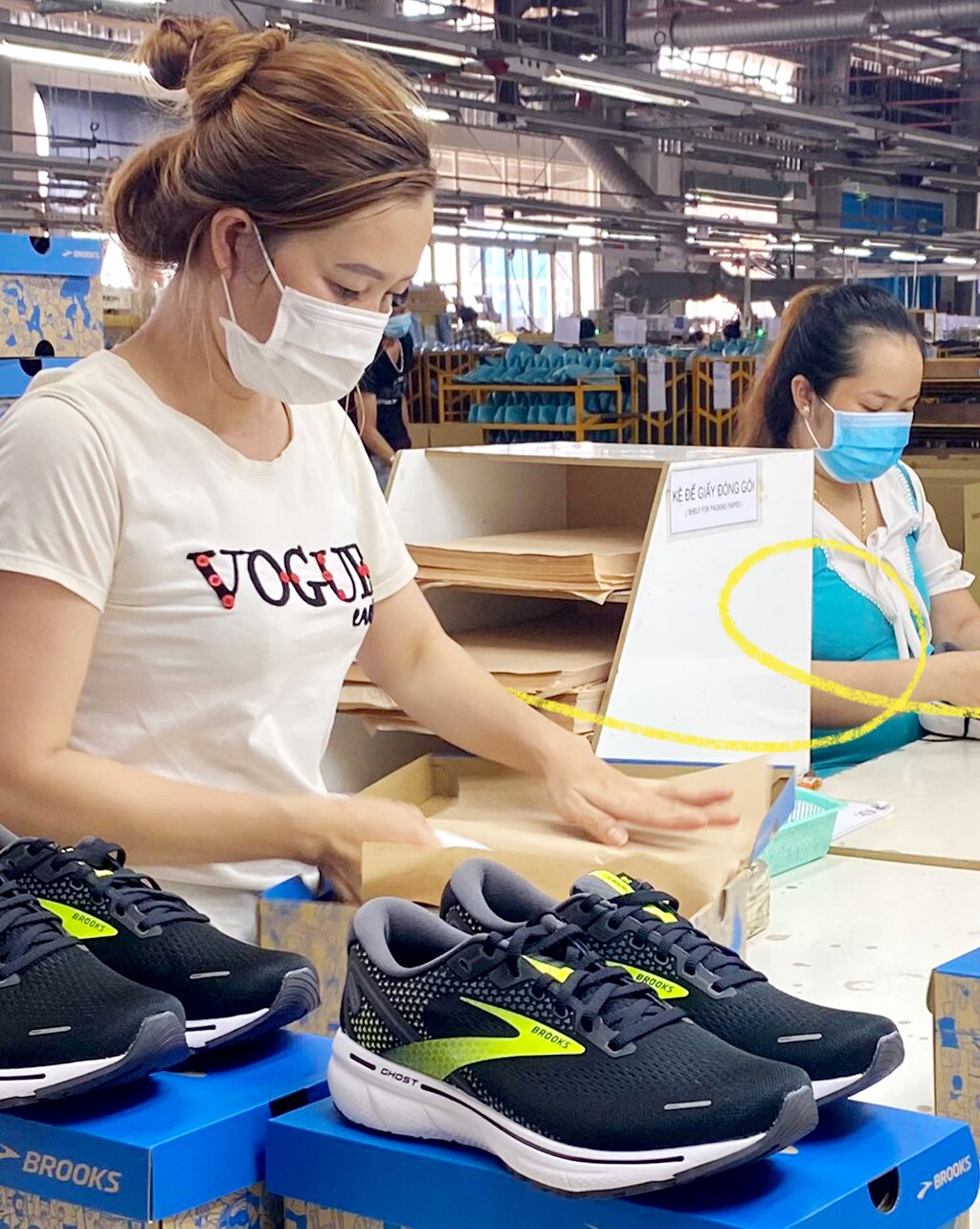 Mujeres trabajando en el empaquetado de zapatillas Brooks