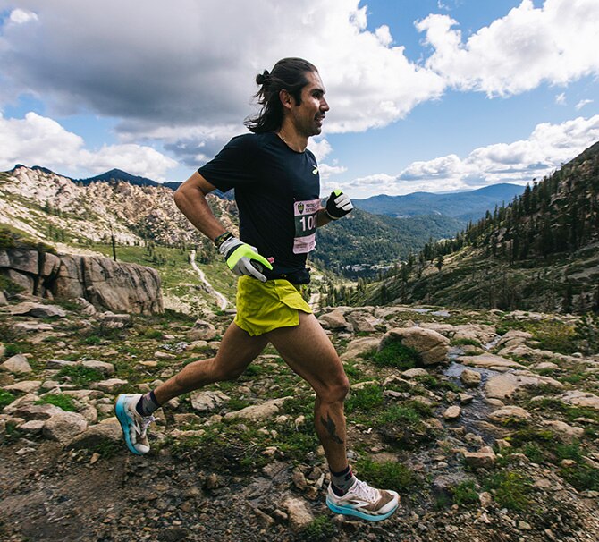 A trail runner on rocky terrain