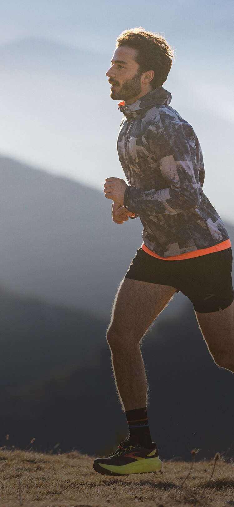 Models with Brooks clothing running on a trail track