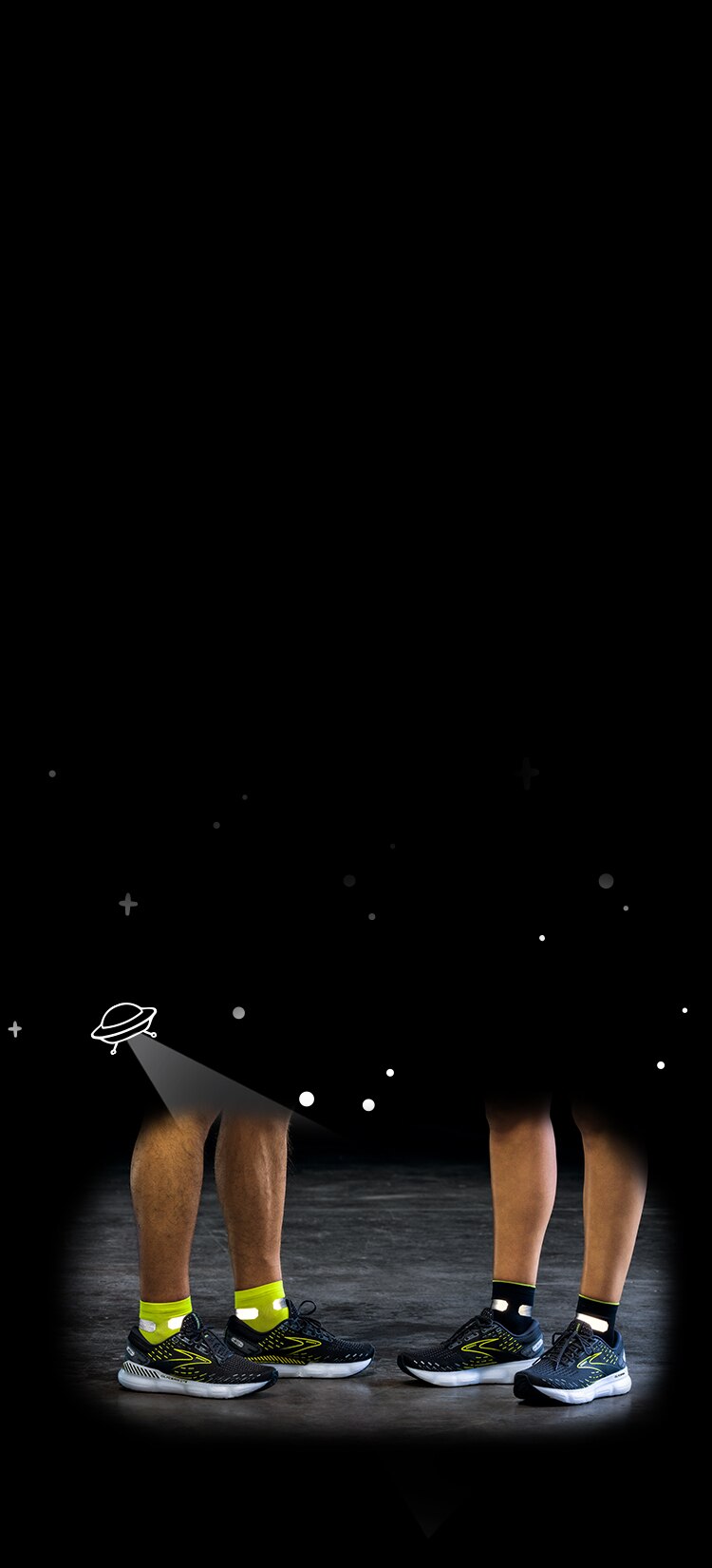 Dark background with UFO illustration shining light on reflective running gear