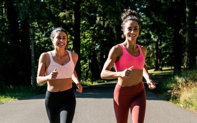 Two women running outdoors in Drive Convertible and Dare Crossback Run Bras