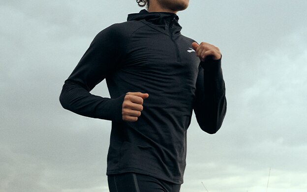 Angle shot of a man wearing Brooks Running long sleeve outerwear