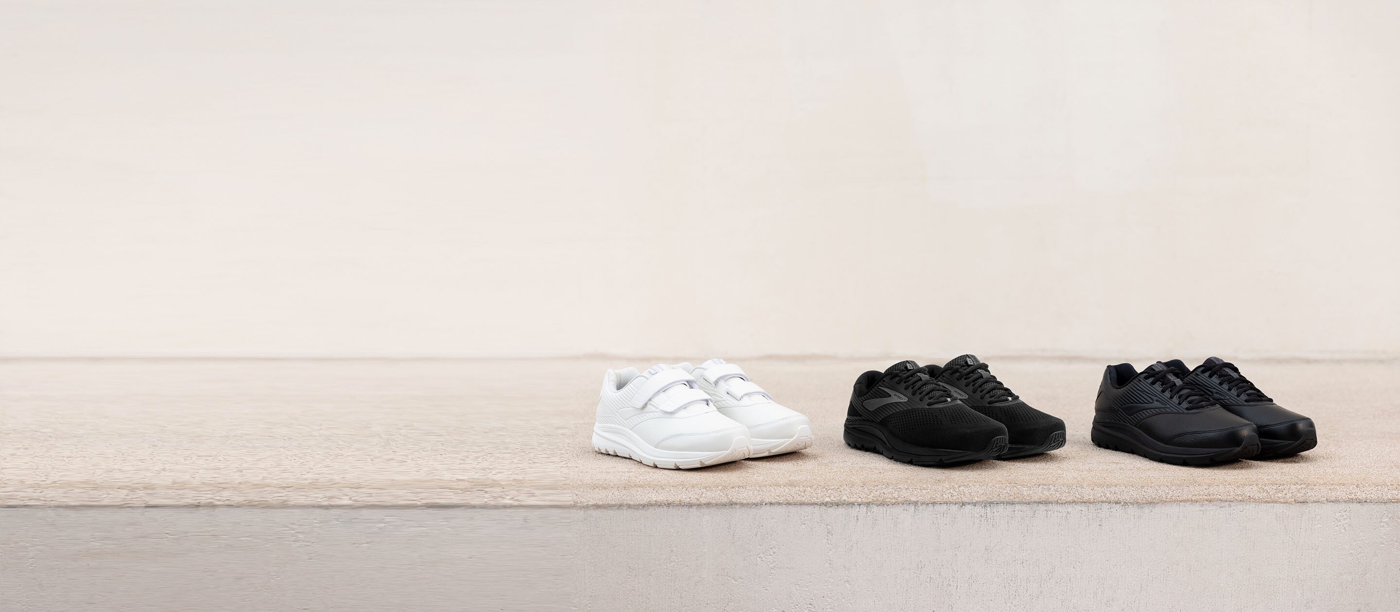 The Addiction Walker 2 V-Strap in white, the Addiction Walker Suede in black, and the Addiction Walker 2 in black, lined up together