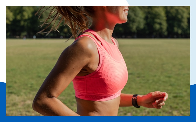 A close up of a woman running outdoors in a Drive Mesh Run Bra