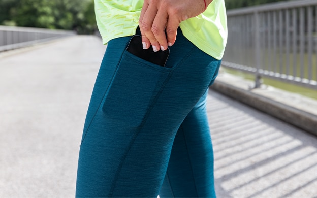 Close-up shot of a woman wearing a blue tight from Brooks Running