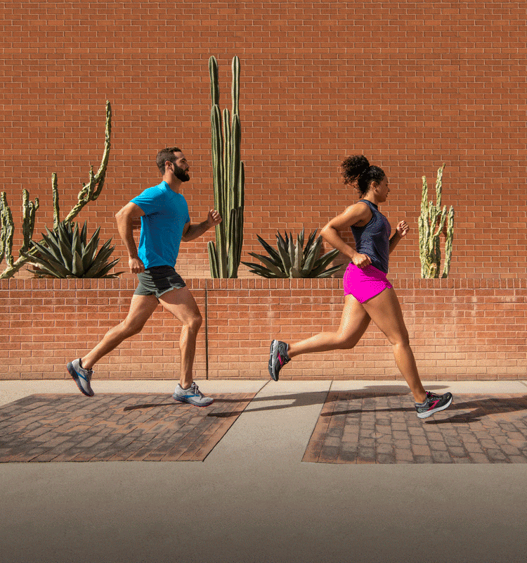 A man and a woman running outside in the Ghost 14.