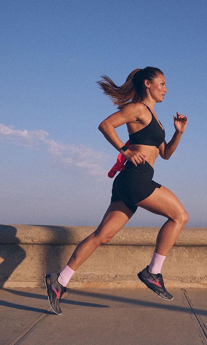 Side camera shot of a runner wearing Brooks gear